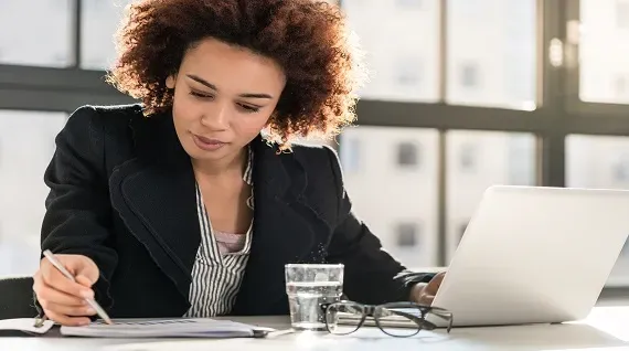 women sitting in front of a desk women sitting in front of a desk